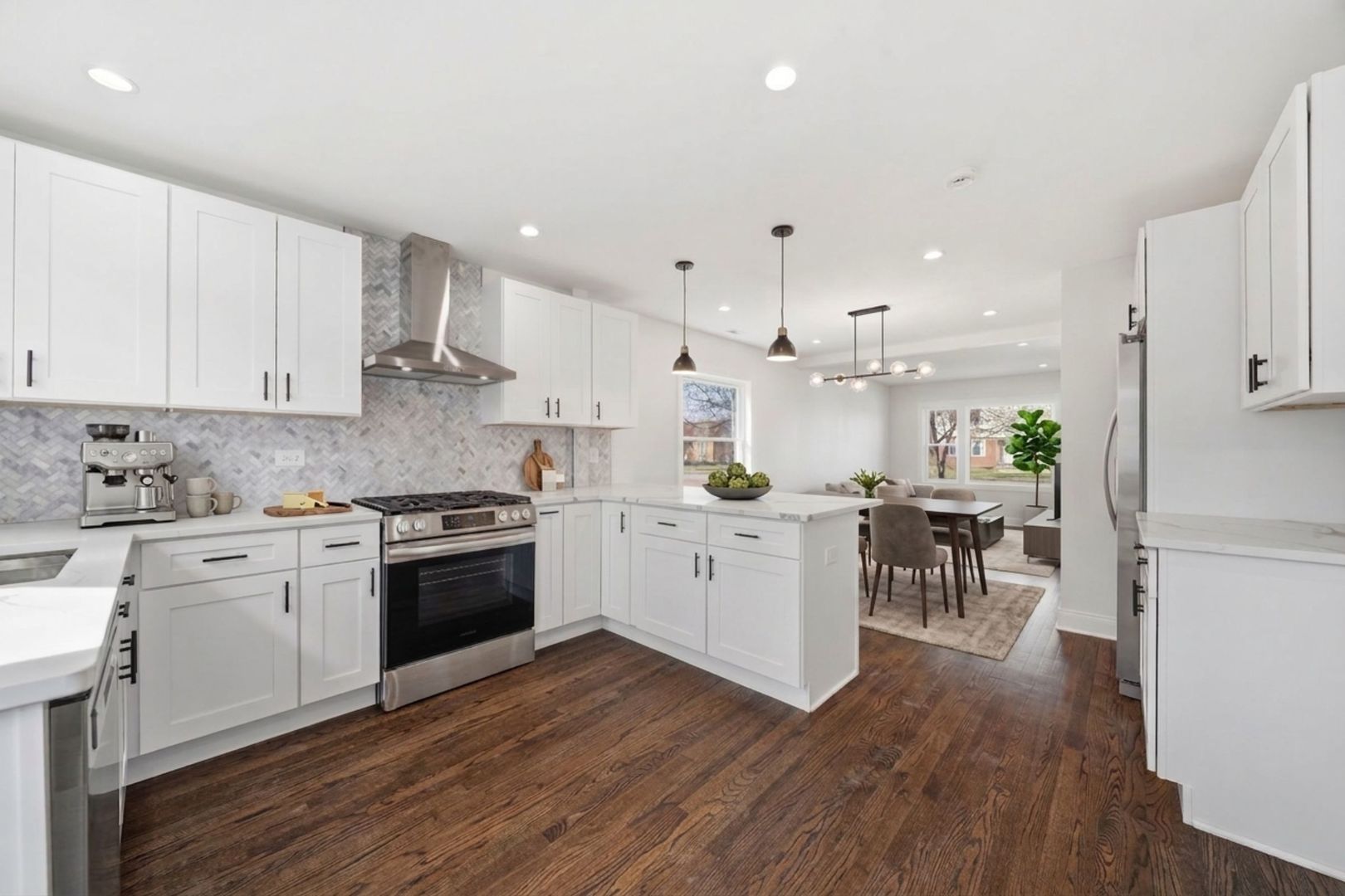 7851 Suburban Lane Bridgeview, IL 60455 - Photo 13 of 50 a kitchen with white cabinets stainless steel appliances and wooden floor