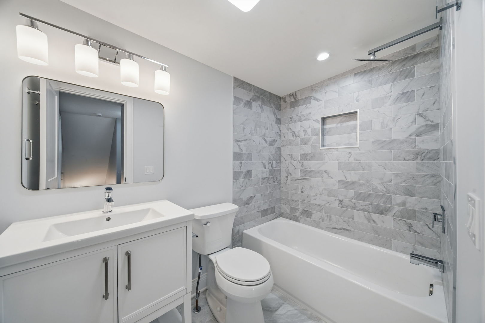 7851 Suburban Lane Bridgeview, IL 60455 - Photo 25 of 50 a bathroom with a bathtub shower sink vanity mirror and toilet