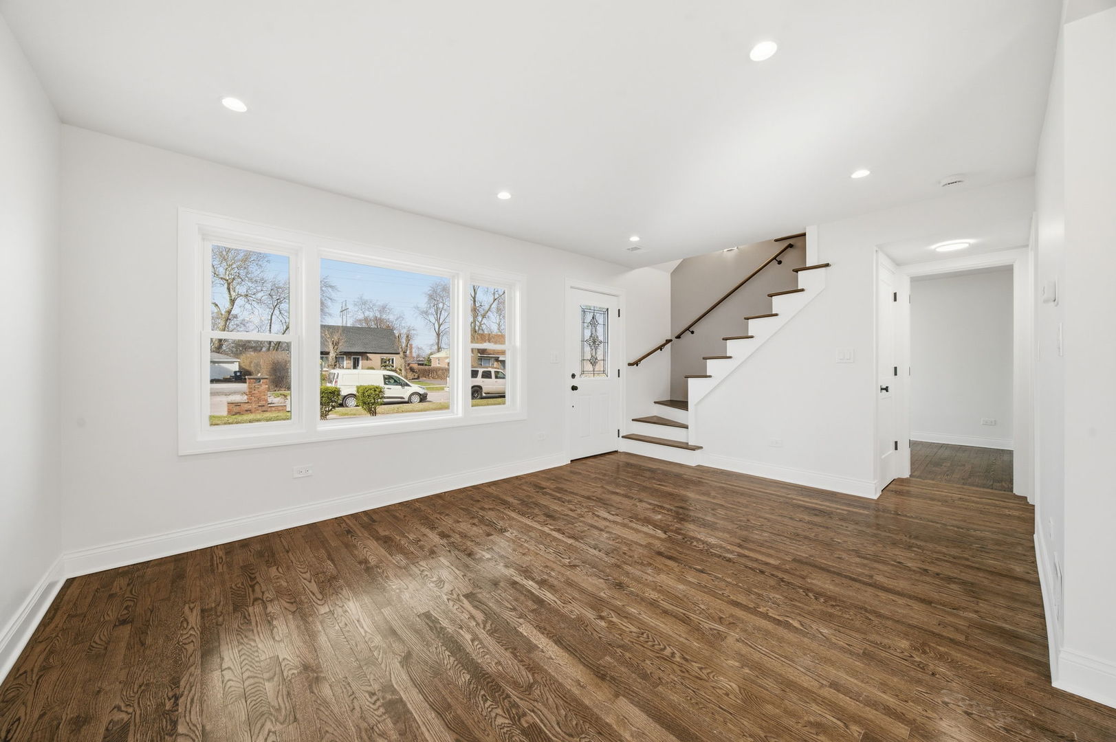 7851 Suburban Lane Bridgeview, IL 60455 - Photo 3 of 50 a view of an empty room with wooden floor and a window