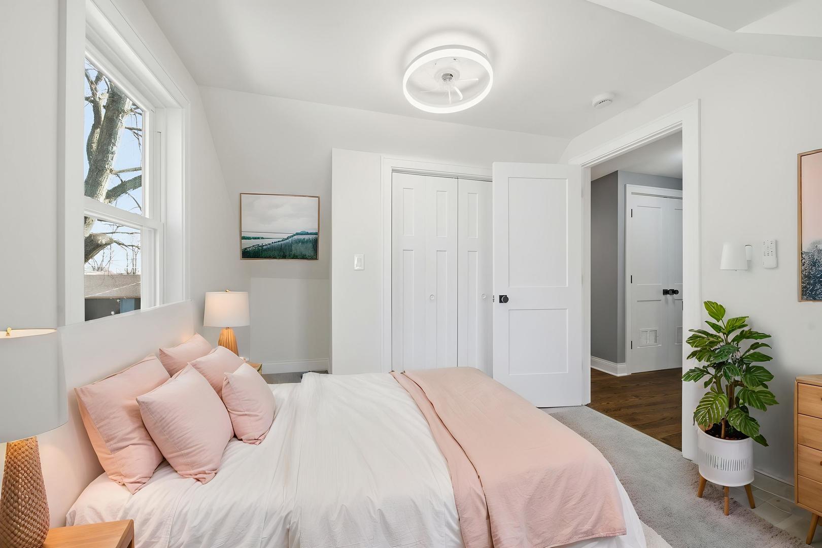 7851 Suburban Lane Bridgeview, IL 60455 - Photo 34 of 50 a bedroom with a bed and a chandelier