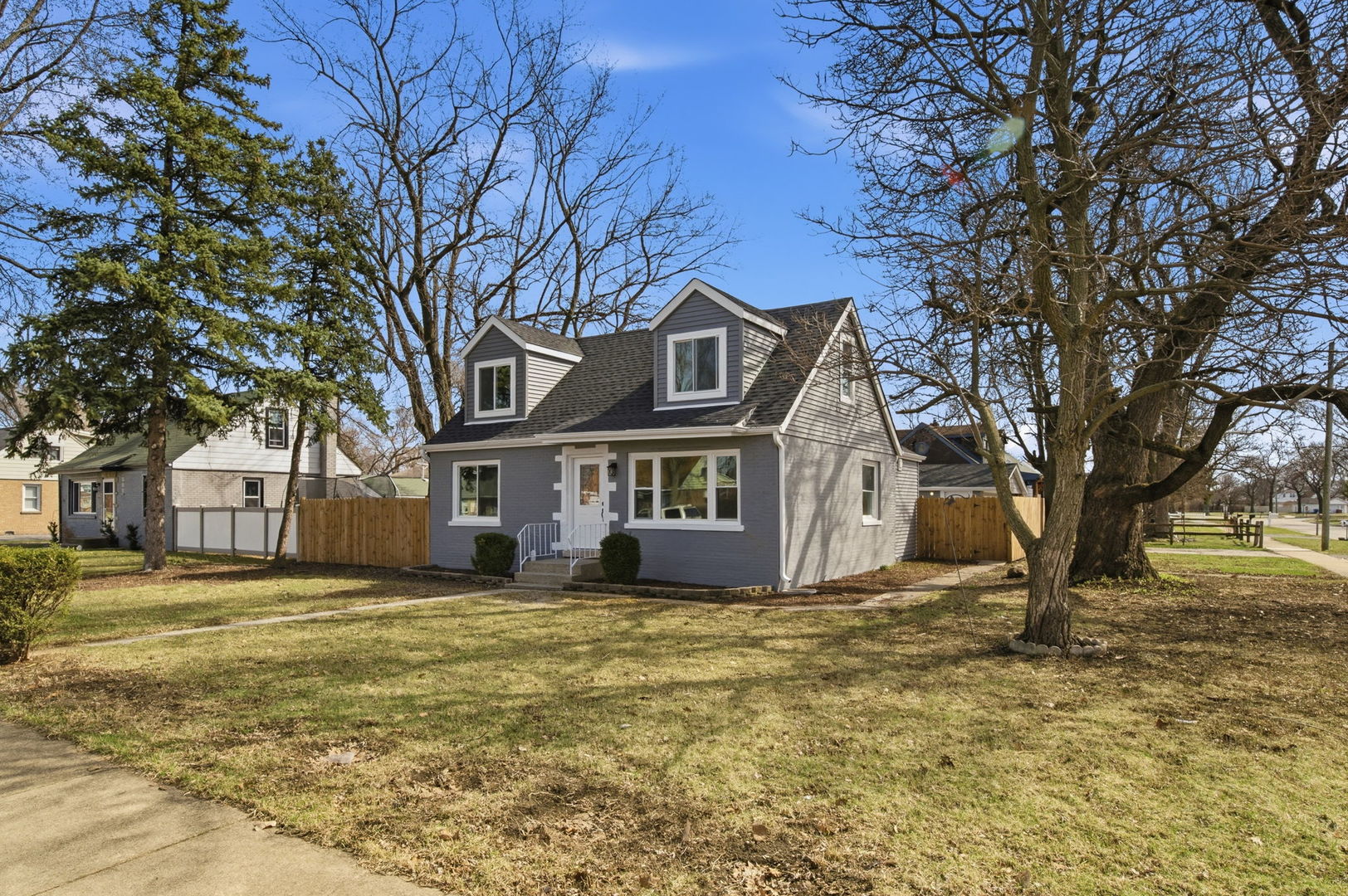7851 Suburban Lane Bridgeview, IL 60455 - Photo 35 of 50 a front view of residential houses with yard and trees