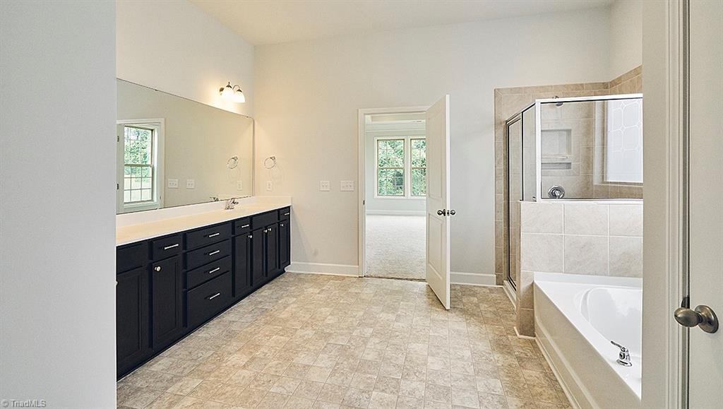 7159 Conrad Farm Road, Unit 188 Pfafftown, NC 27040 - Photo 15 of 26 Master Bath-Home at Conrad Farm has White cabinets,framed mirrors,tile floor,granite countertops