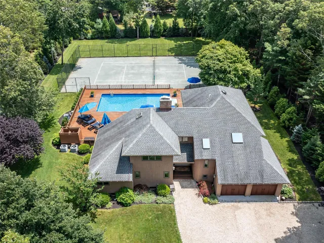an aerial view of a house with a yard and balcony