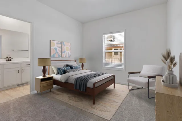 a bedroom with a bed and a lamp on table