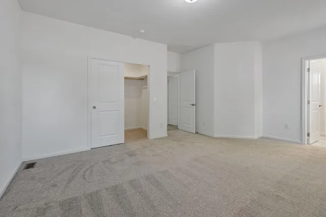 a view of an empty room and closet area