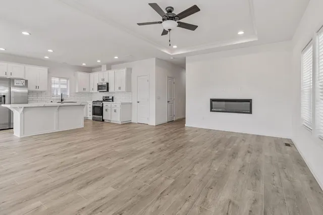 a view of a kitchen with a sink and wooden floor