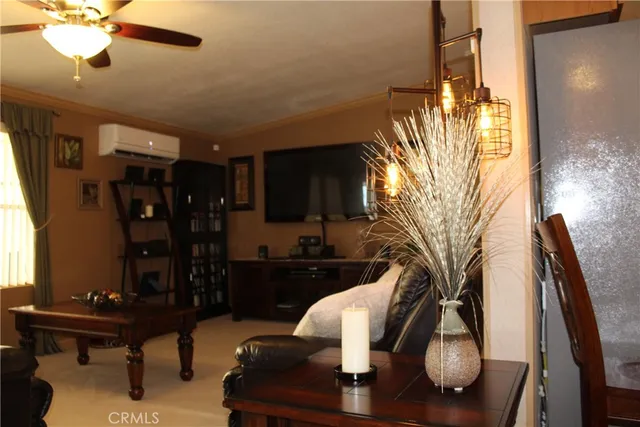 a large bed sitting in a bedroom next to a window and a chandelier