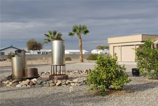 a vase of flowers sitting on a table in front of a house