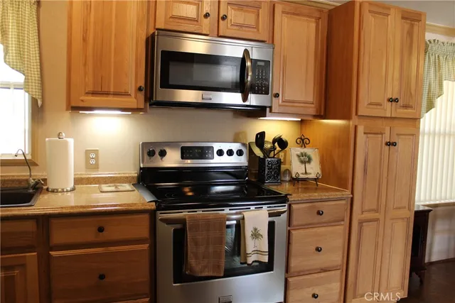 a bathroom with a granite countertop sink and mirror