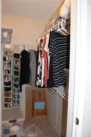 a view of a hallway with cabinets