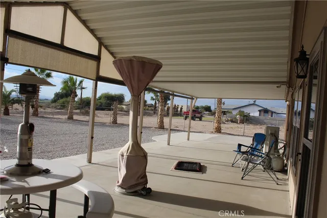 a view of a patio with a table and chairs