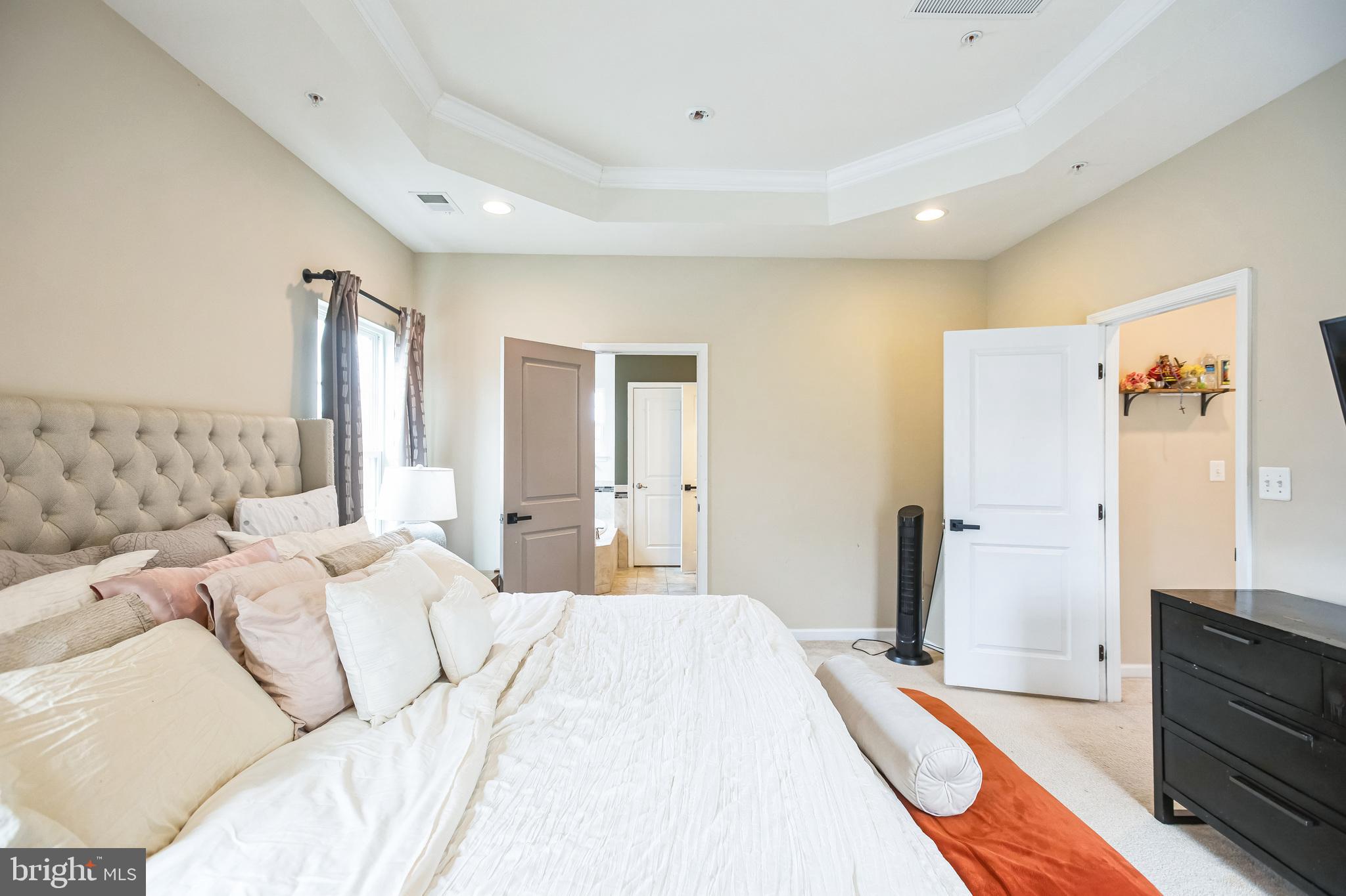 2601 St Marys View Road Accokeek, MD 20607 - Photo 15 of 33 a spacious bedroom with a bed and a large mirror