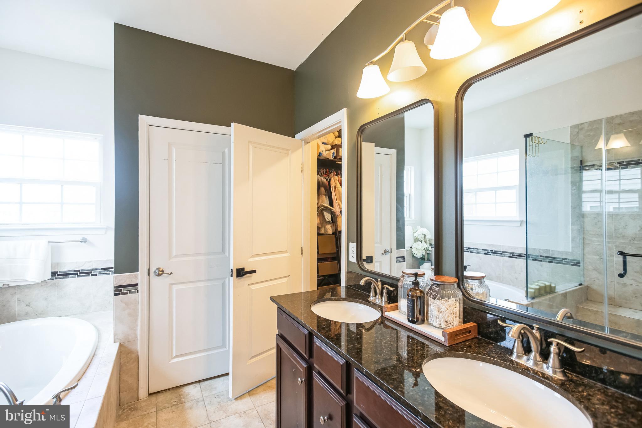 2601 St Marys View Road Accokeek, MD 20607 - Photo 17 of 33 a bathroom with a granite countertop sink and a mirror