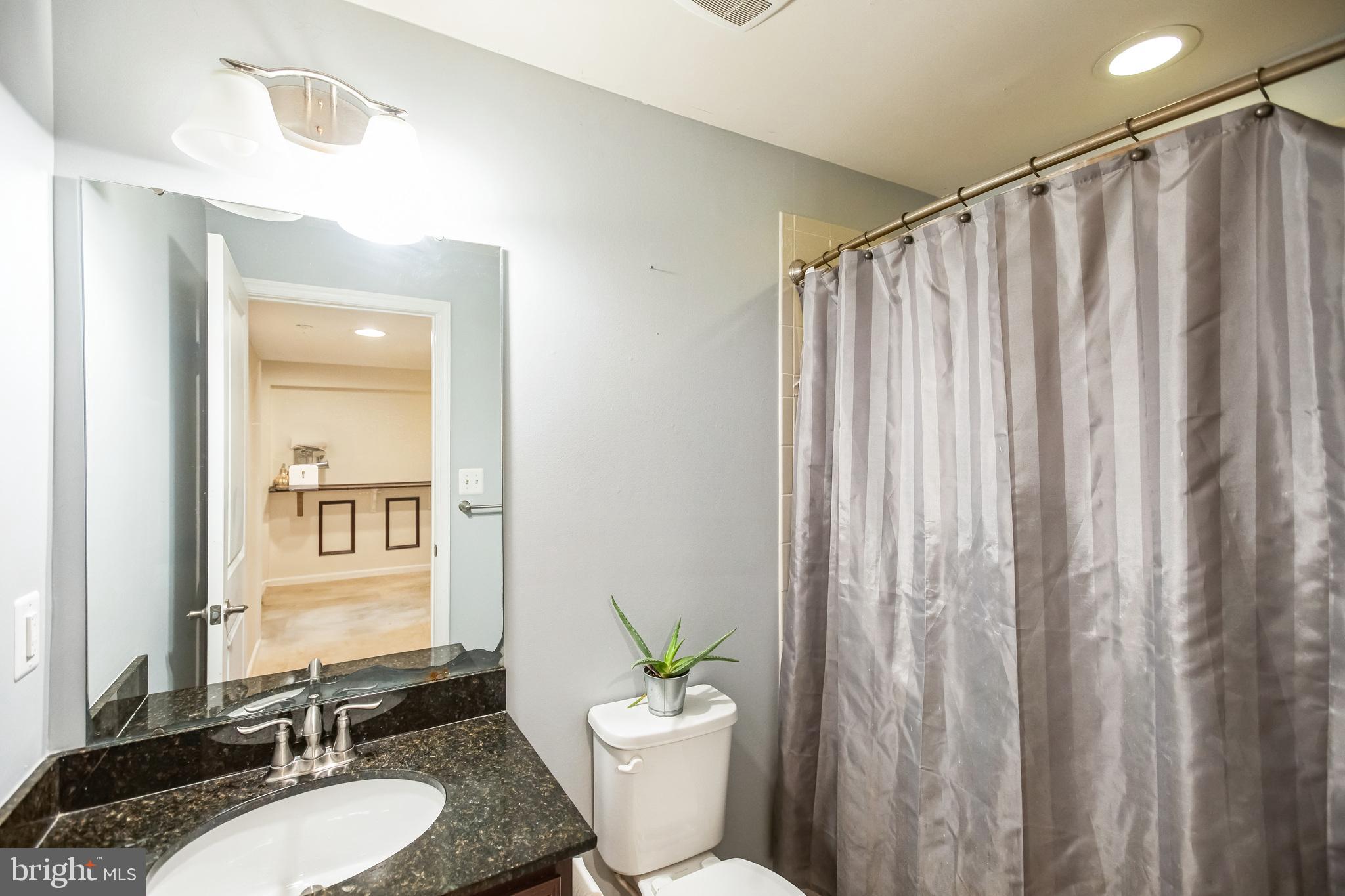 2601 St Marys View Road Accokeek, MD 20607 - Photo 28 of 33 a bathroom with a granite countertop sink and a mirror