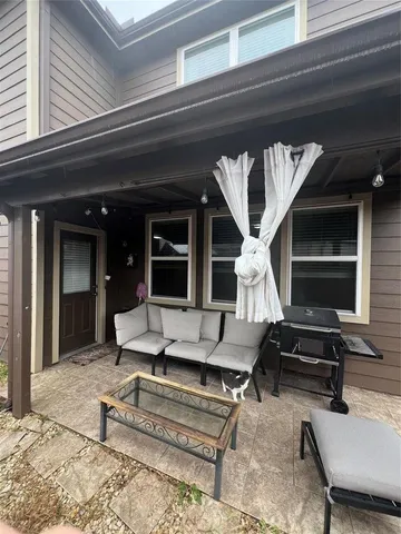 a living room with furniture a rug and a piano