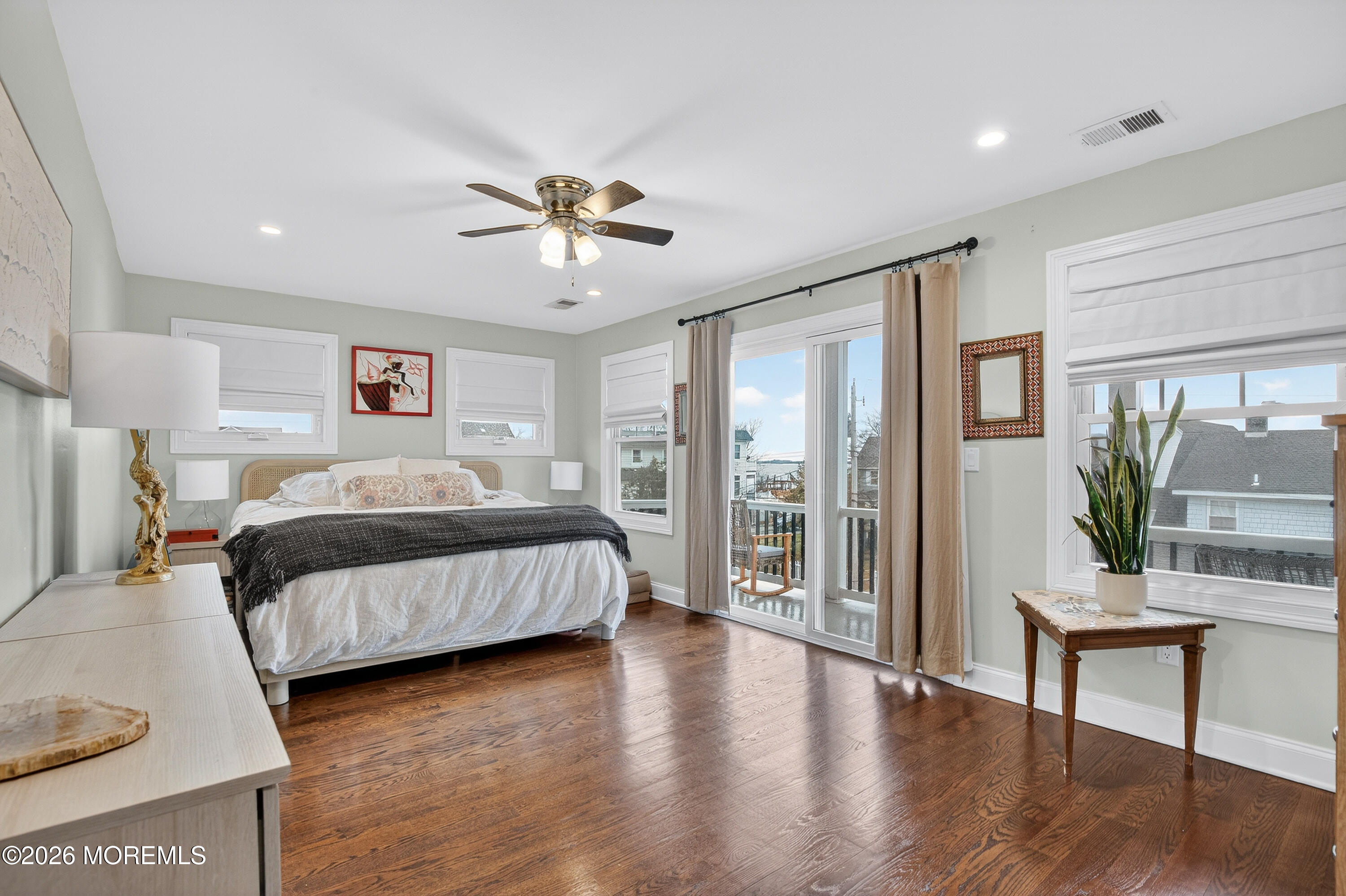 27 5th Street Highlands, NJ 07732 - Photo 20 of 62 a bedroom with a large bed and a potted plant