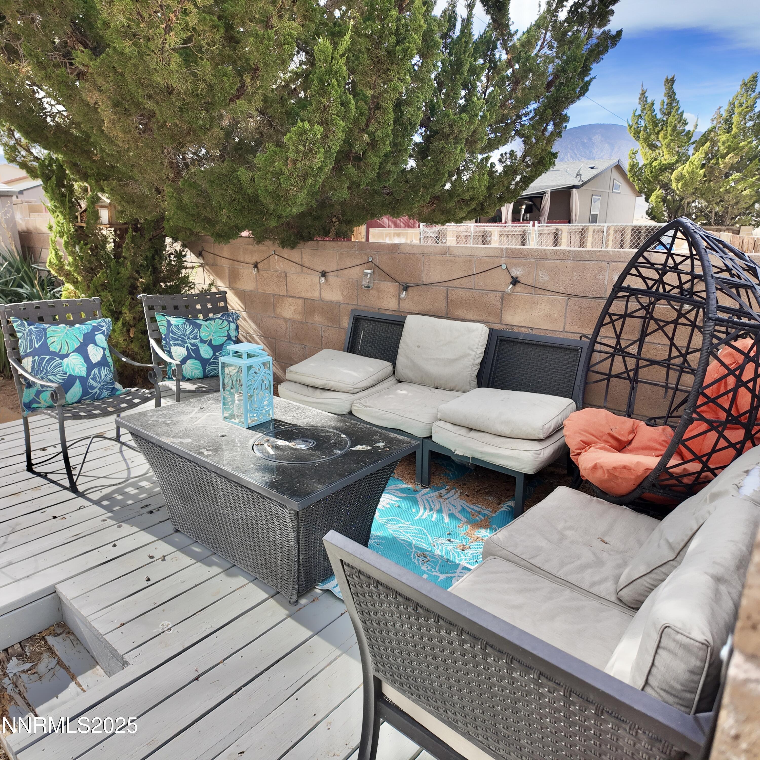 455 Connely Street Hawthorne, NV 89415 - Photo 39 of 43 a view of a patio with couches and a dining table and chairs with wooden floor