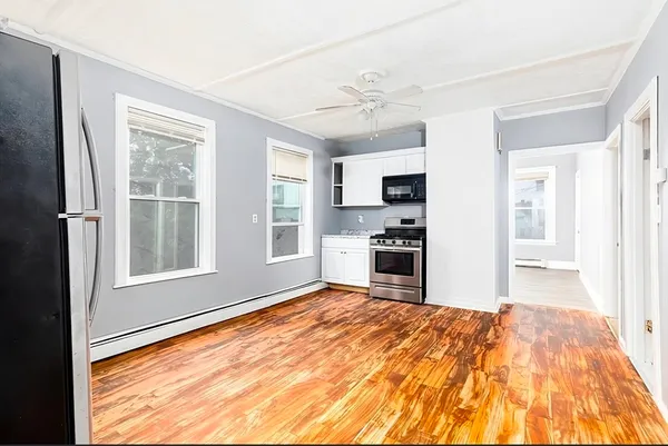 a view of a kitchen with microwave and windows