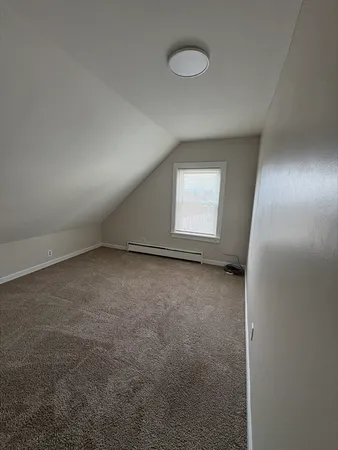 a view of an empty room and a window