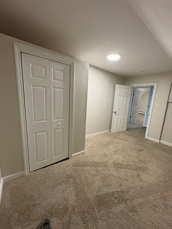 a view of an empty room and wooden door