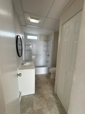 a bathroom with a sink a toilet and a mirror