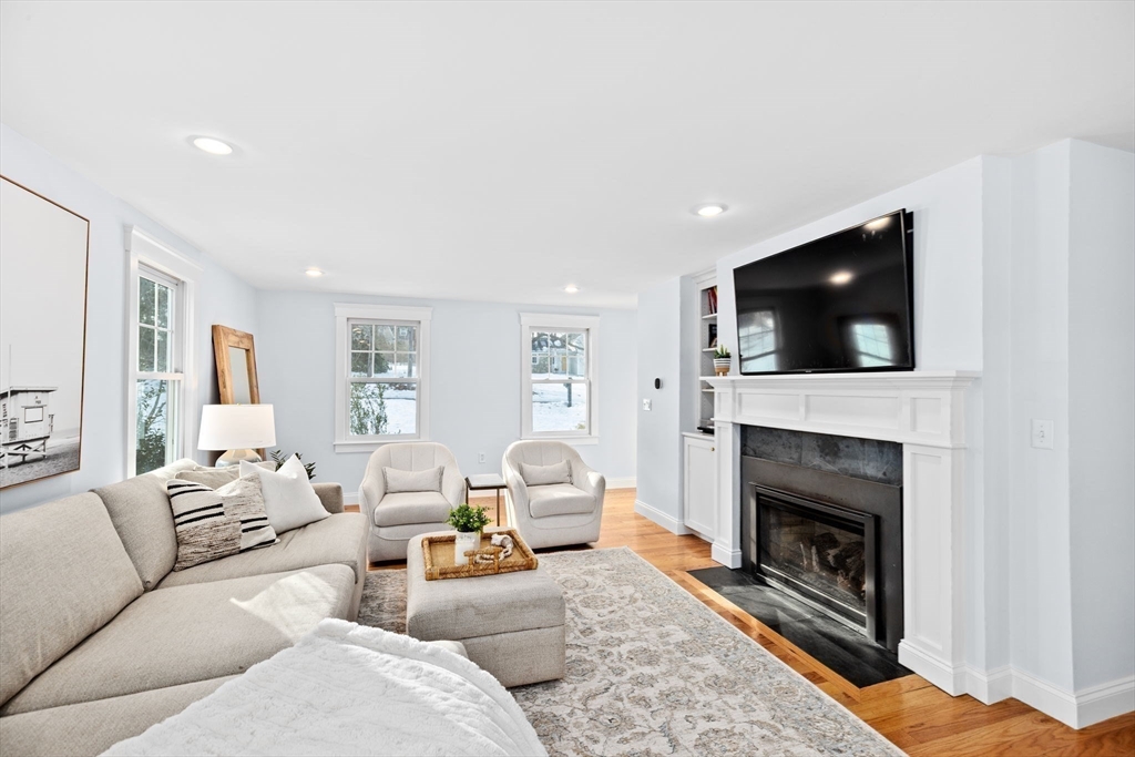 54 Dreamwold Road Scituate, MA 02066 - Photo 13 of 41 a living room with furniture a fireplace and a flat screen tv