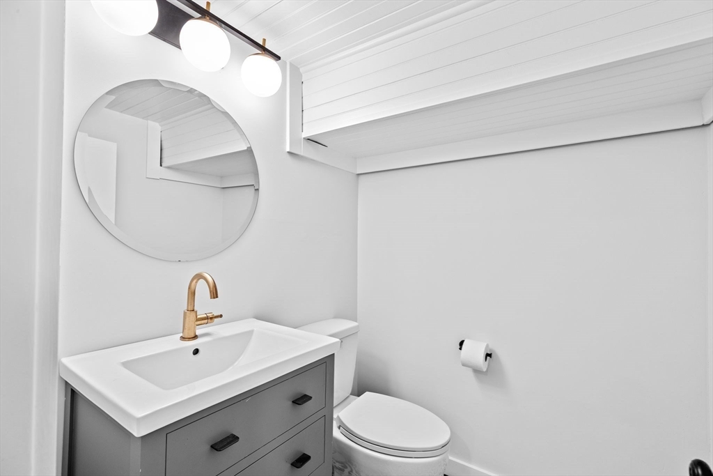 54 Dreamwold Road Scituate, MA 02066 - Photo 30 of 41 a bathroom with a toilet a sink and mirror