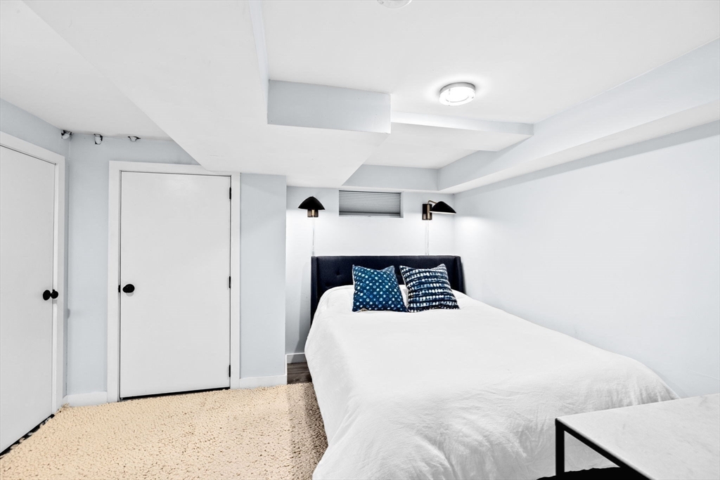 54 Dreamwold Road Scituate, MA 02066 - Photo 32 of 41 a bedroom with a bed and a refrigerator