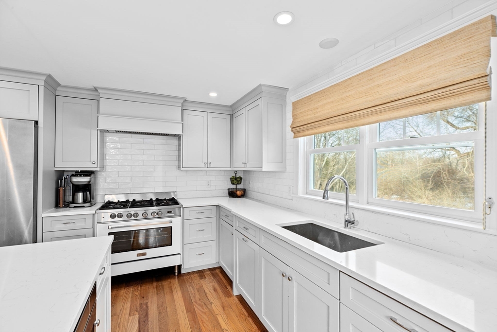 54 Dreamwold Road Scituate, MA 02066 - Photo 7 of 41 a kitchen with a sink a stove and cabinets