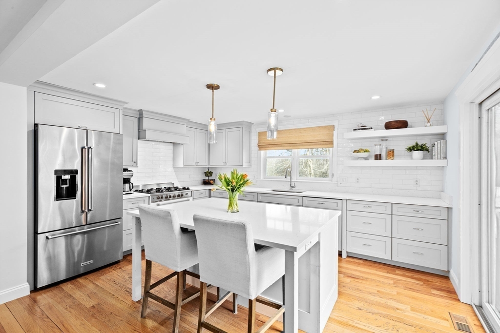 54 Dreamwold Road Scituate, MA 02066 - Photo 8 of 41 a kitchen with white cabinets and white appliances