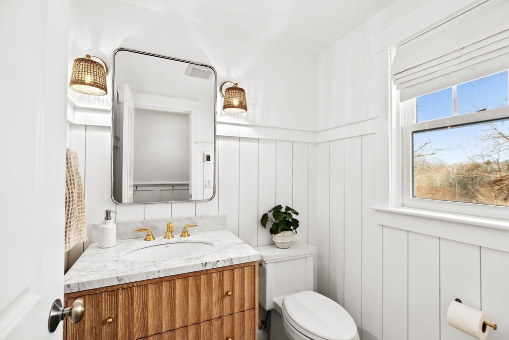54 Dreamwold Road Scituate, MA 02066 - Photo 9 of 41 a bathroom with a granite countertop sink and a mirror with toilet