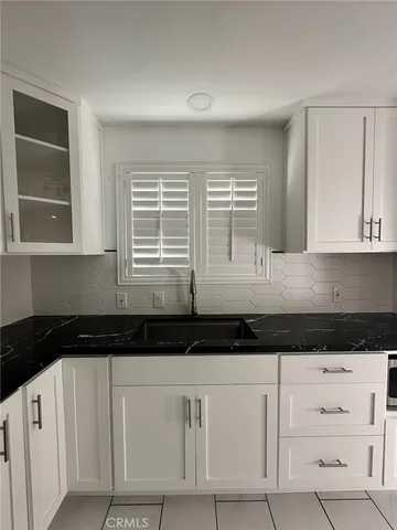 a view of a livingroom with an empty space and a window