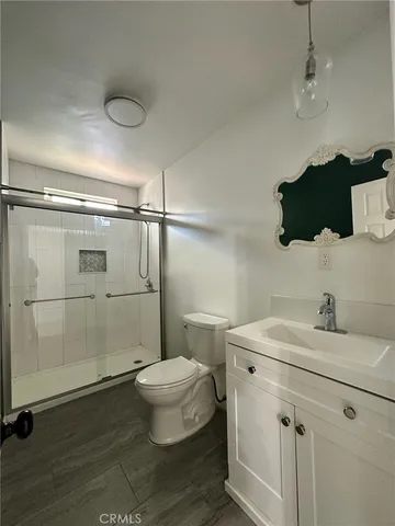a bathroom with a glass shower door