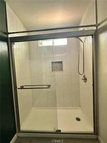 a bathroom with a shower and a tub
