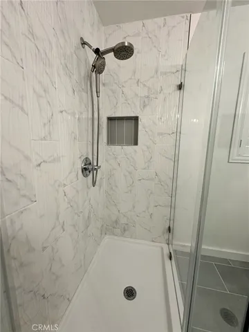 a view of a backyard with plants and a fire pit