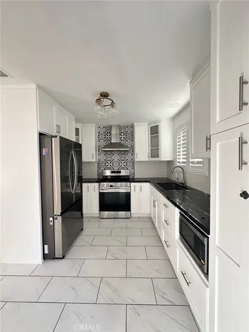 a stove top oven sitting inside of a kitchen