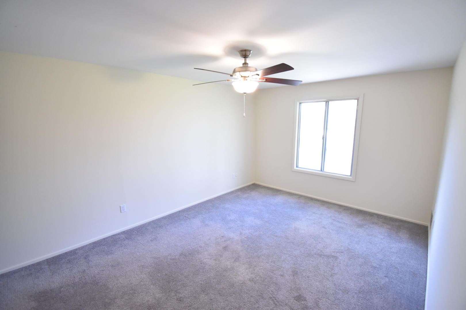 4618 Northfox Lane, Unit 6 McHenry, IL 60050 - Photo 11 of 15 an empty room with windows and fan