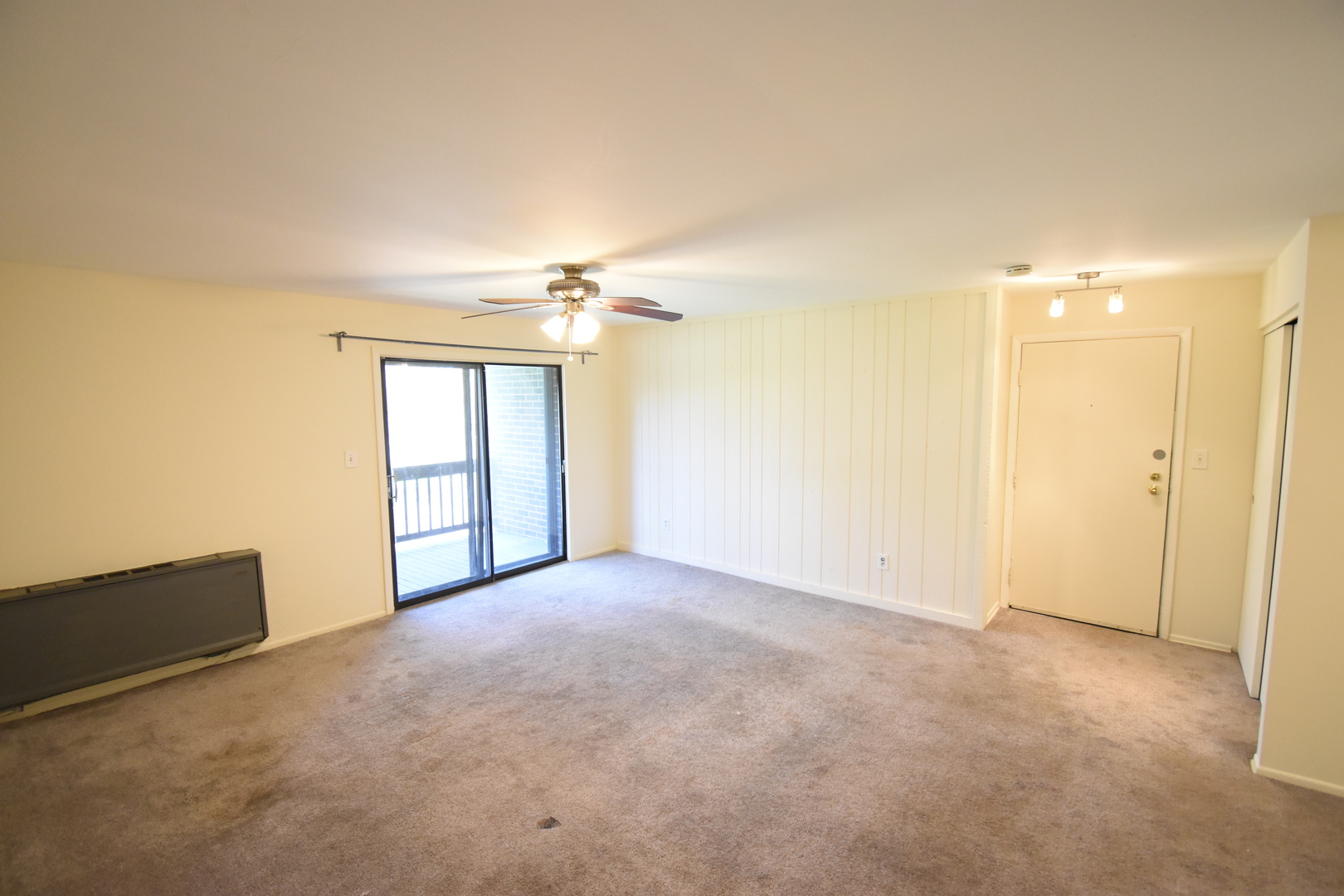 4618 Northfox Lane, Unit 6 McHenry, IL 60050 - Photo 2 of 15 an empty room with chandelier fan and windows