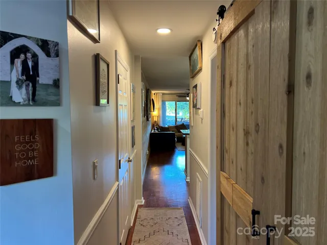 a view of hallway with wooden floor