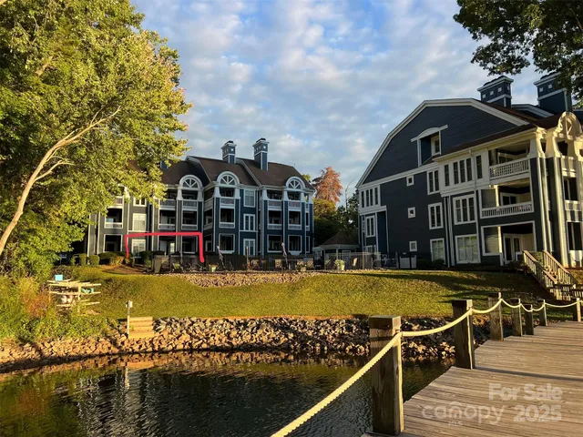 a view of a swimming pool with a bench and trees in the background