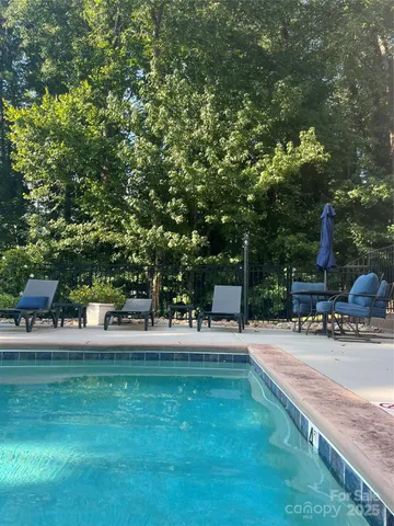 a swimming pool with outdoor seating and yard