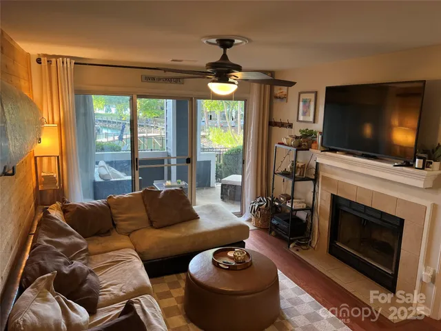 a living room with furniture a fireplace and a flat screen tv