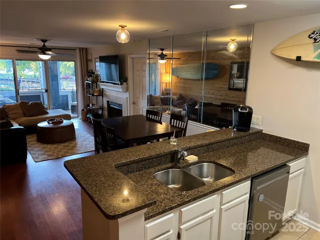 a kitchen with kitchen island a sink appliances and a counter top space