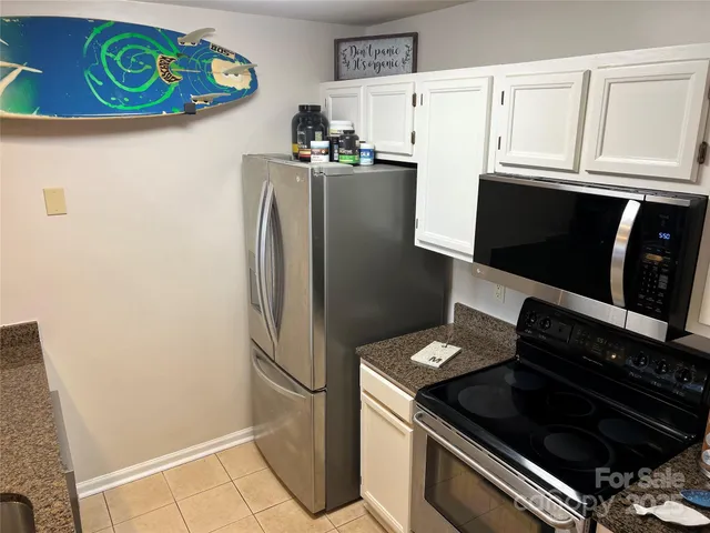 a kitchen with stainless steel appliances a refrigerator a stove and a microwave