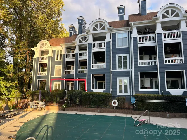 a front view of a multi story residential apartment building with a yard