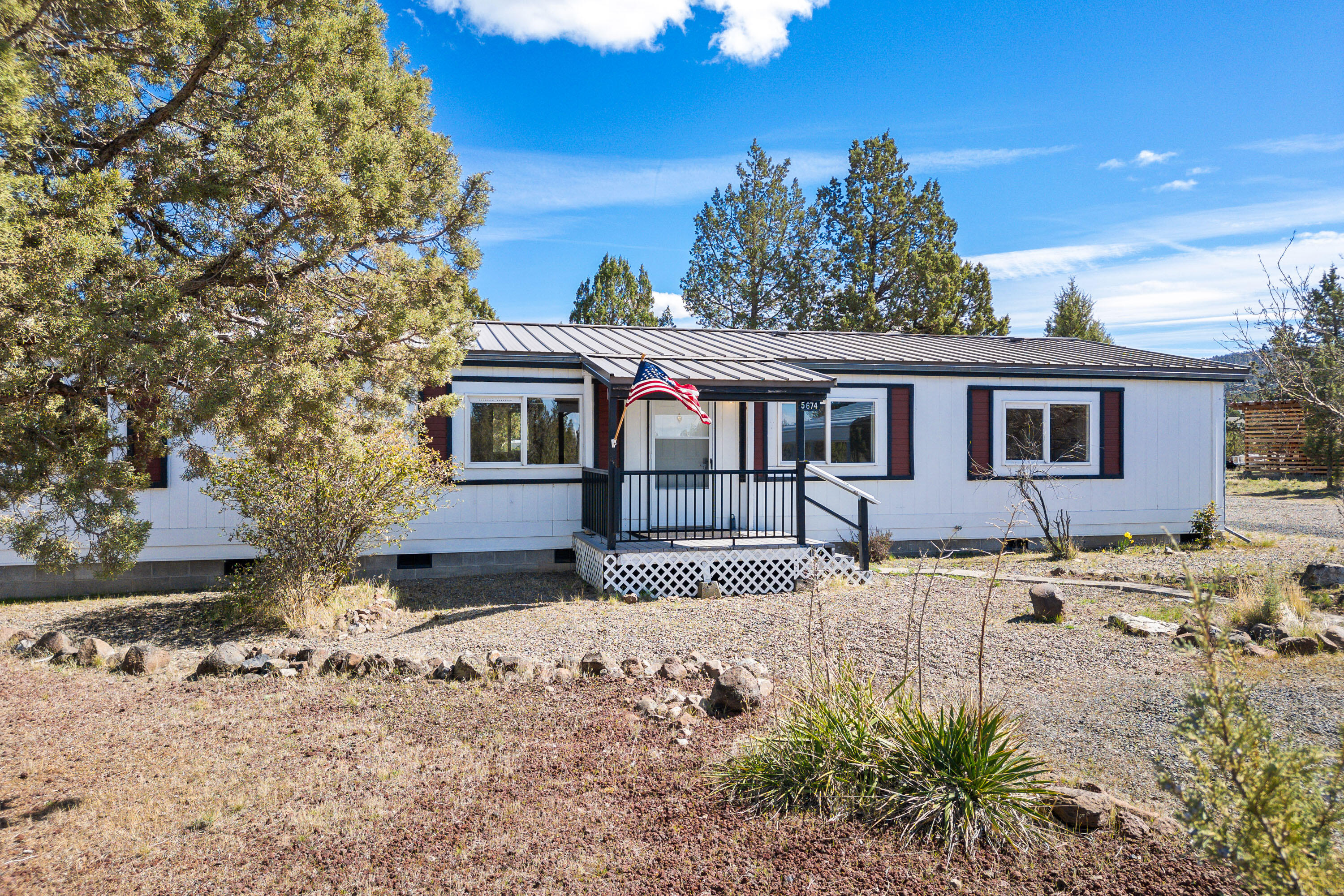 5674 Southeast Davis Loop Prineville, OR 97754 - Photo 3 of 48 a front view of a house with a yard