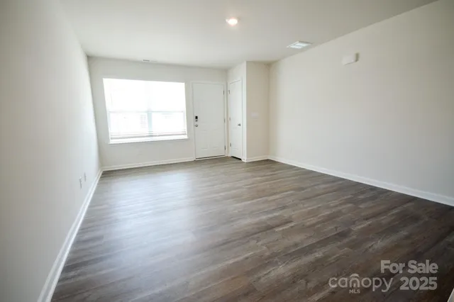 a view of entryway with wooden floor and stairs