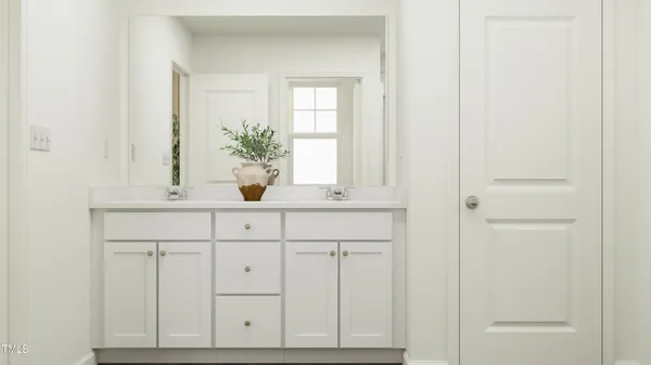a bathroom with a sink vanity and a mirror