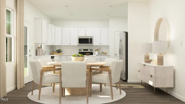 a kitchen with stainless steel appliances white cabinets and wooden floor