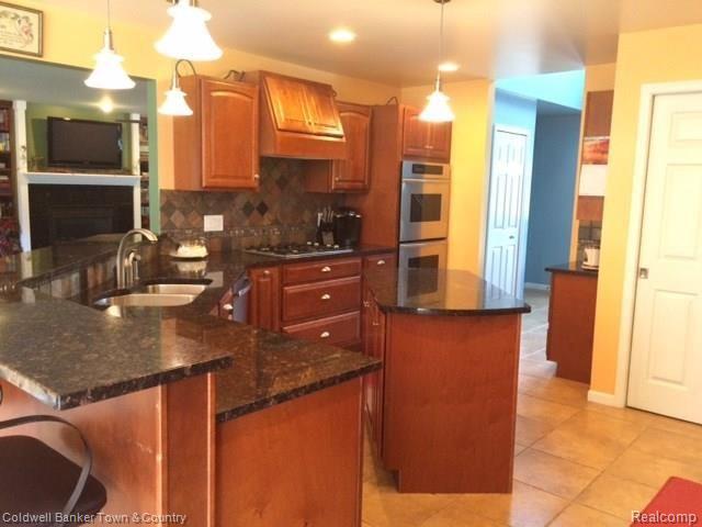 4770 Golf Club Road Howell, MI 48843 - Photo 22 of 59 Island Kitchen with granite counters